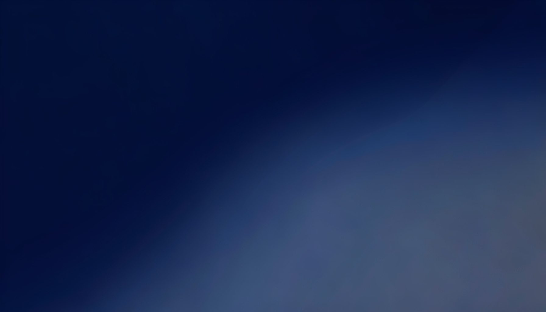 Deep navy blue gradient fading into muted steel tones, abstract and atmospheric